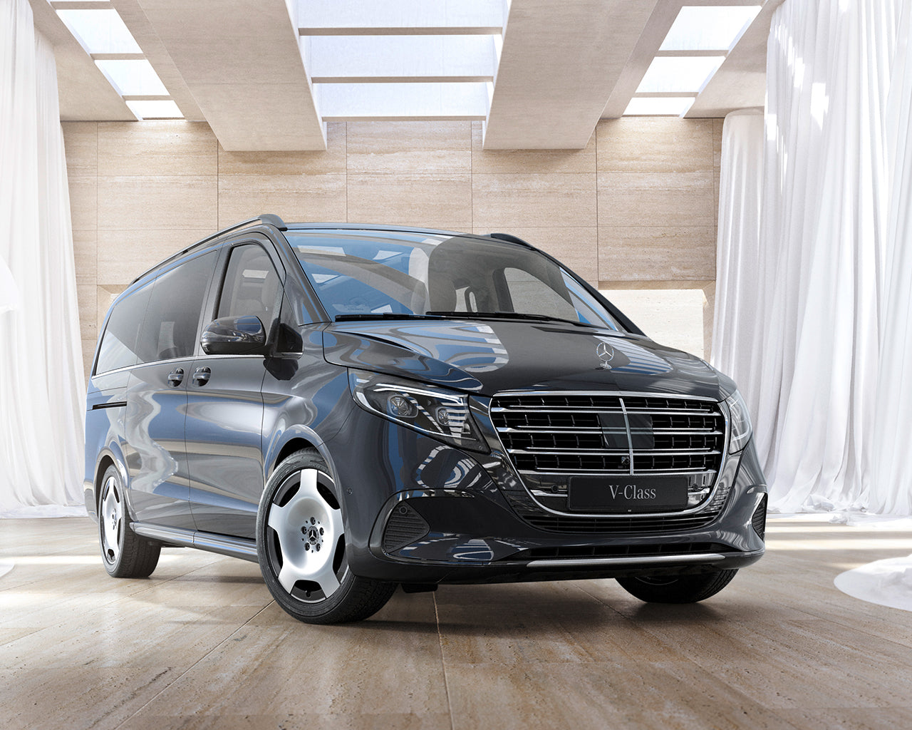 Black Mercedes-Benz Sprinter Van parked in a showroom floor with white curtains and big skylights