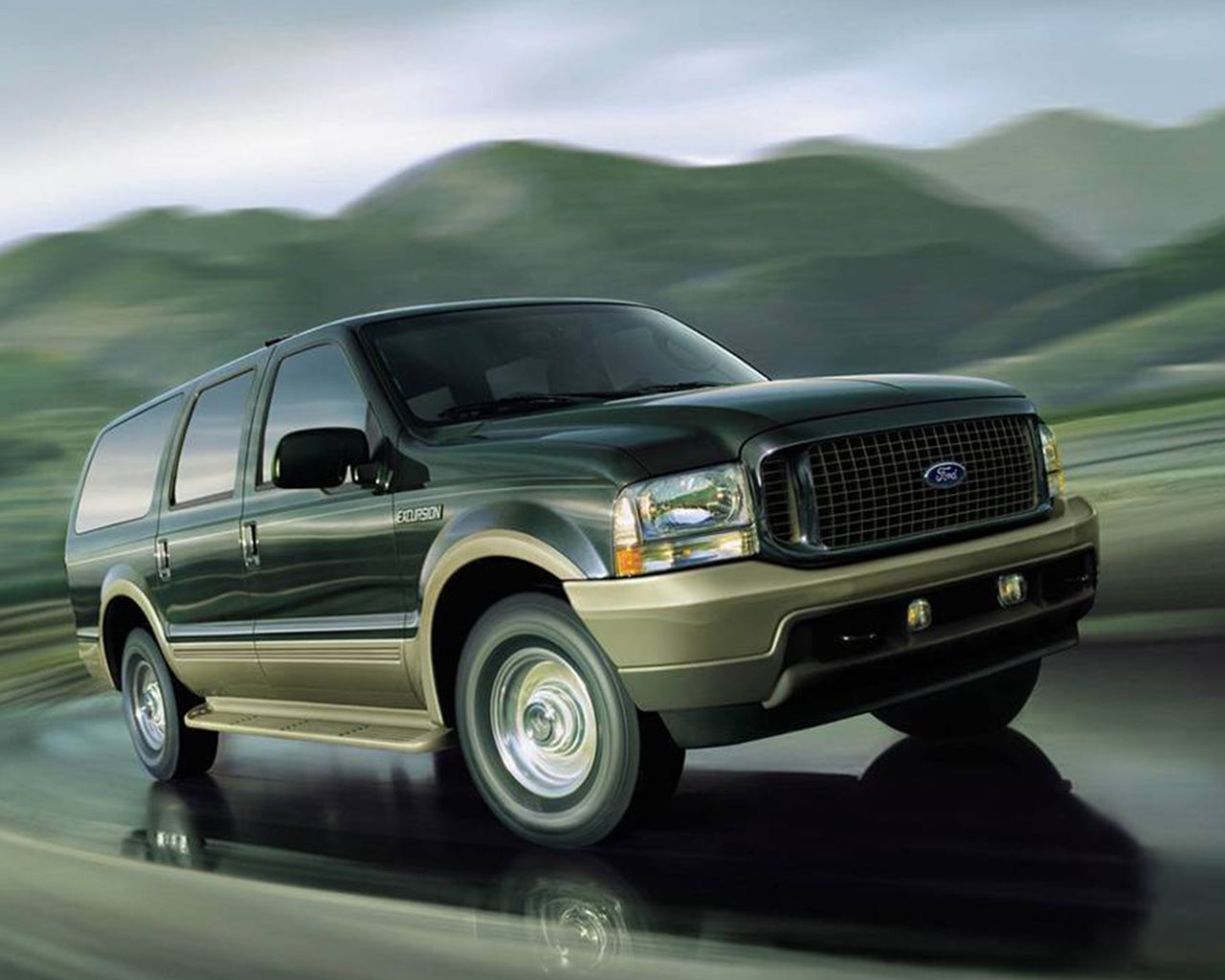 Two tone black and beige Ford Excursion driving fast and taking a turn with blurred background