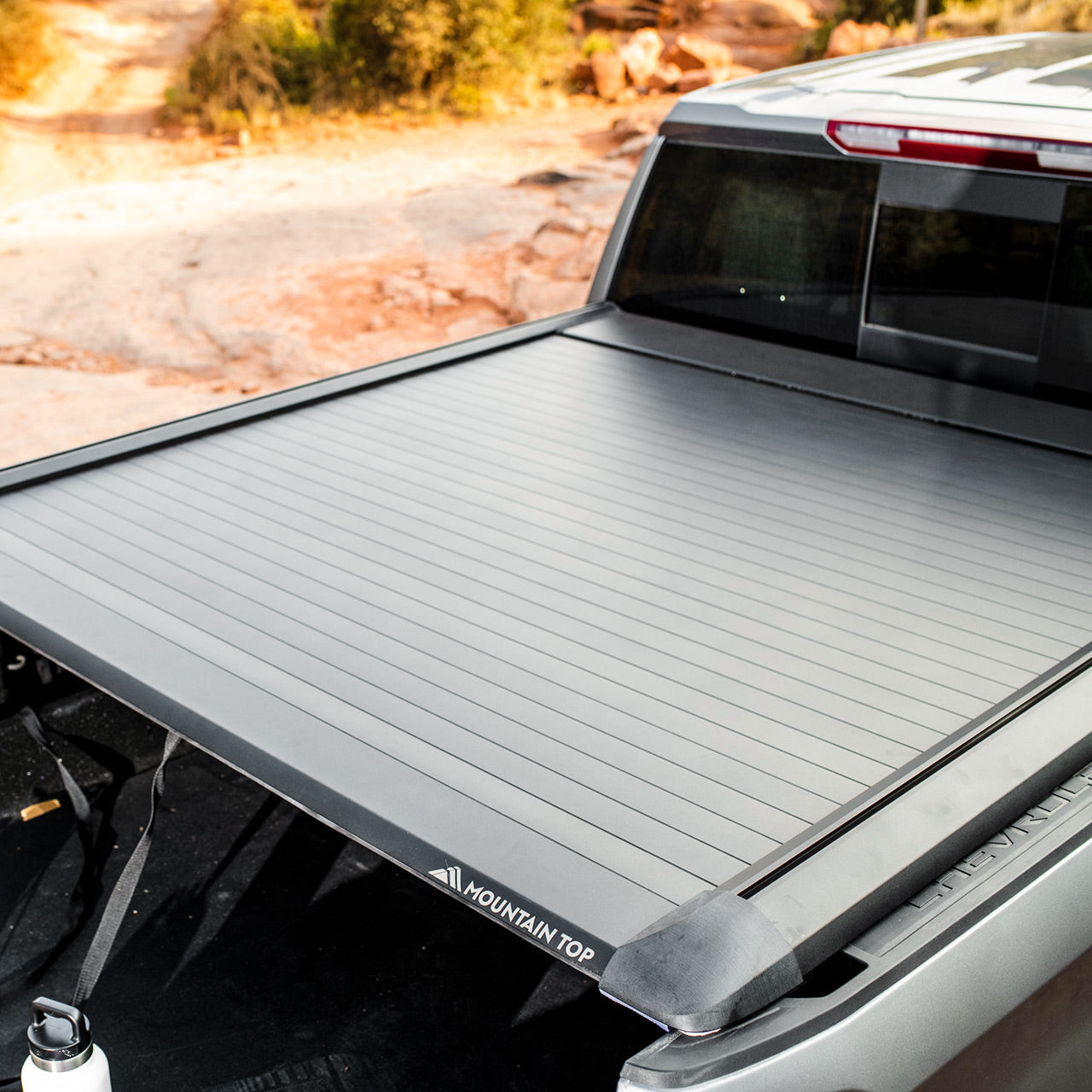 Detailed view of Black Chevy Silverado Truck with retractable roll truck bed cover