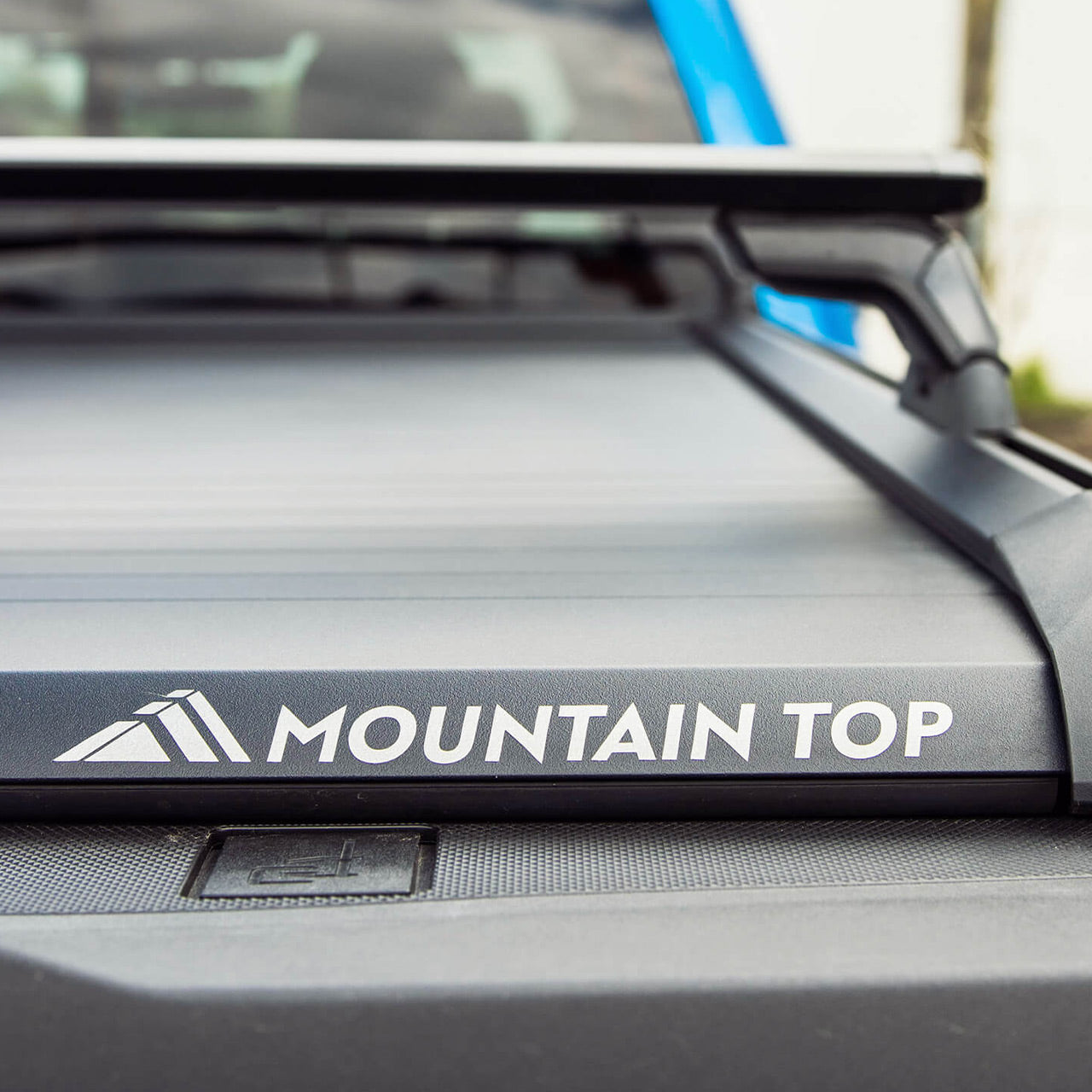 Detailed closeup of Mountain Top Retractable Tonneau truck bed cover fitted on Ford F150 with Mountain Top Accessory Racks