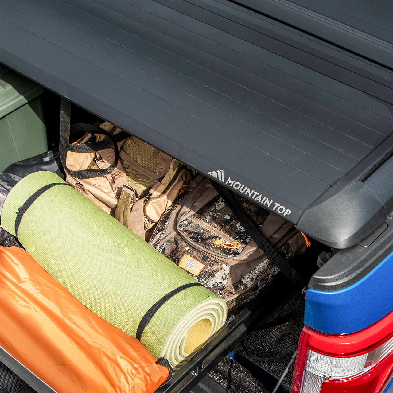 EVO-M Retractable Truck bed cover on a Ford F150 protecting camping gear