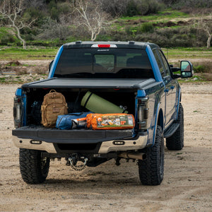 Blue Ford F250 Super Duty covering camping gear and tents with Mountain Top Tonneau Truck bed cover